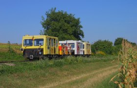Zayataler Schienenzaxi, © VNLB Ein gelbes Schienenfahrzeug fährt durch eine ländliche Gegend mit Bäumen und Feldern.