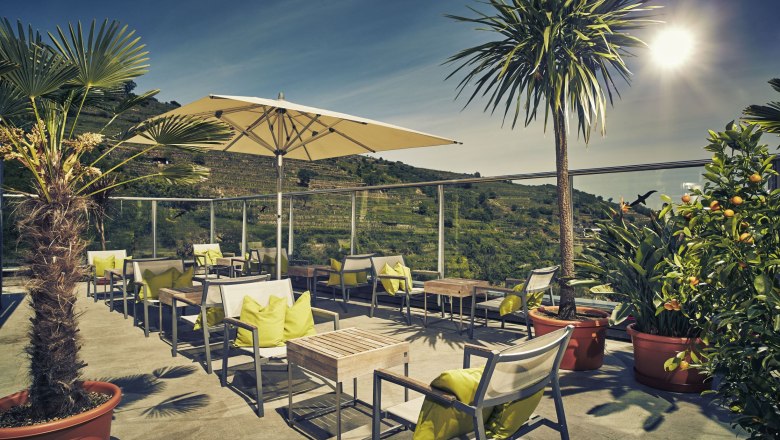 Steigenberger Krems, Sky Garden, © Steigenberger Hotel and Spa, Andreas Hofer Terrasse des Steigenberger Krems mit Sonnenschirmen und Pflanzen.