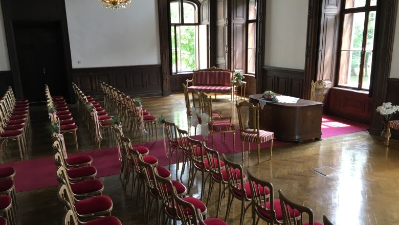Veranstaltungsschloss Margarethen am Moos, © Veranstaltungsschloss Margarethen am Moos Saal im Schloss mit roten Stühlen und einem roten Teppich