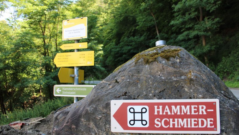 Aggsbach Hammerschmiede Wegweiser, © Donau Nö Tourismus_Vera Pulker Wegweiser zur Hammerschmiede in Aggsbach, umgeben von Bäumen.