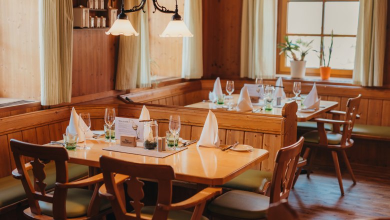 Hier kommen Waldviertler Spezialitäten auf den Tisch, © Niederösterreich Werbung/Daniela Führer Gemütliches Restaurant mit Holzmöbeln, gedeckten Tischen und Pflanzen am Fenster.