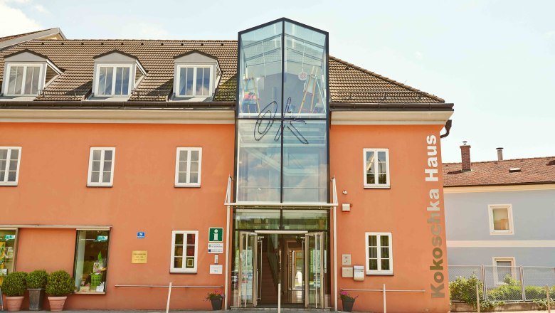 Oskar Kokoschkahaus, © Klaus Engelmayer Das Oskar Kokoschkahaus mit orangefarbener Fassade und gläsernem Eingang.