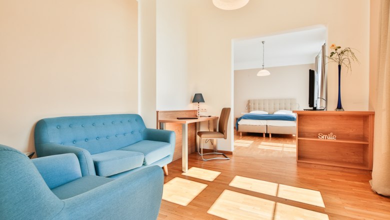 Hotel Unter den Linden Zimmer 208, © Hotel Unter den Linden Helles Hotelzimmer mit blauen Möbeln und Doppelbett.