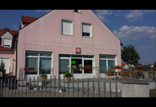 Bäckerei-Café Hiessberger, © Donau Niederösterreich Außenansicht eines rosa Gebäudes mit der Aufschrift 'Bäckerei-Café Hiessberger'. Vor dem Gebäude stehen Tische und Stühle.