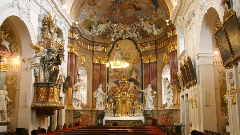 Minoritenkirche, © Stadtgemeinde Tulln Innenansicht der Minoritenkirche mit reich verziertem Altar und Deckenfresken.