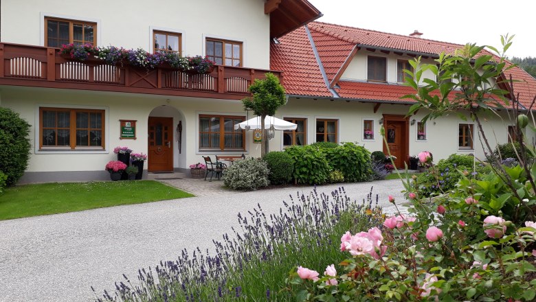 Außenansicht, © Familie Rosinger Außenansicht eines Hauses mit Blumen und Garten.