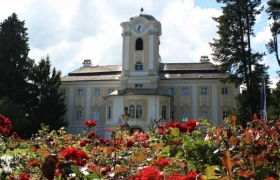 Schloss Rosenau, © Schloss Rosenau Schloss Rosenau mit blühenden roten Rosen im Vordergrund.