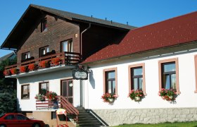 Gasthaus Malzer, © Malzer Walter Gasthaus Malzer mit Blumen geschmücktem Balkon und Fenstern.