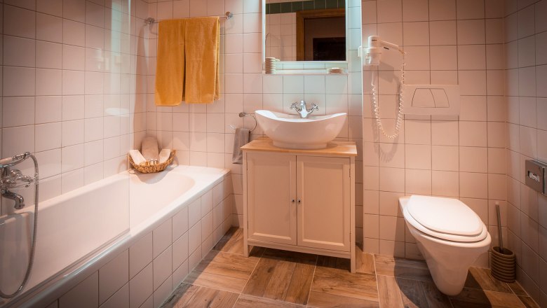 Bad - Deluxe Doppelzimmer mit Gartenblick, © Schlossschenke Modernes Badezimmer mit Badewanne, Waschbecken und Toilette.