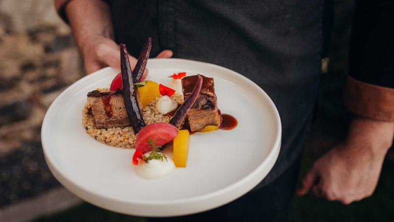 Geschmorte Backerl, Mostsauce, Einkornrisotto, Erdäpfelschaum, Rüben-Variation, © Niederösterreich Werbung/Daniela Führer Ein Teller mit geschmortem Fleisch, Einkornrisotto, Erdäpfelschaum und Rüben-Variation.