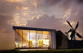 Windmühlheuriger Bergmann, © Alexander Schleissing Moderne Glasarchitektur neben einer traditionellen Windmühle bei Sonnenuntergang.