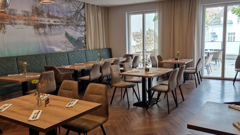 TD-Restaurant 4 Season, © Hendler Innenansicht eines modernen Restaurants mit Holzboden, Tischen und Stühlen.