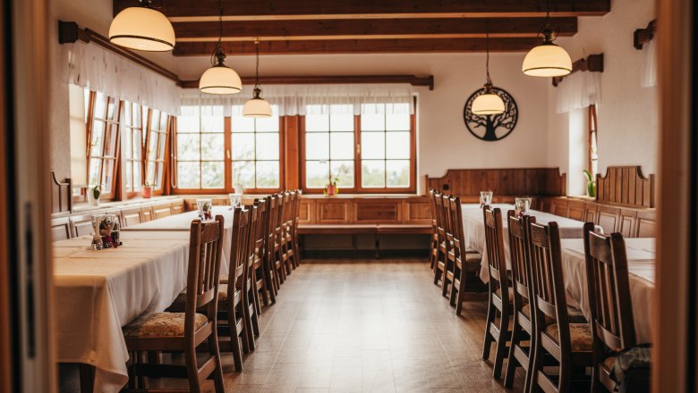 Gemütliches Stüberl, © Niederösterreich Werbung/Daniela Führer Gemütlicher Gastraum mit Holzmöbeln und großen Fenstern.