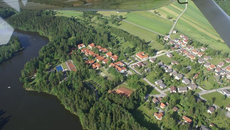 Luftaufnahme Golfplatz und Herrensee, © GC Herrensee Luftaufnahme eines Golfplatzes und eines Sees mit angrenzender Wohnsiedlung.
