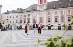 Drei Personen im Business Outfit vor dem barocken Rathaus von St. Pölten