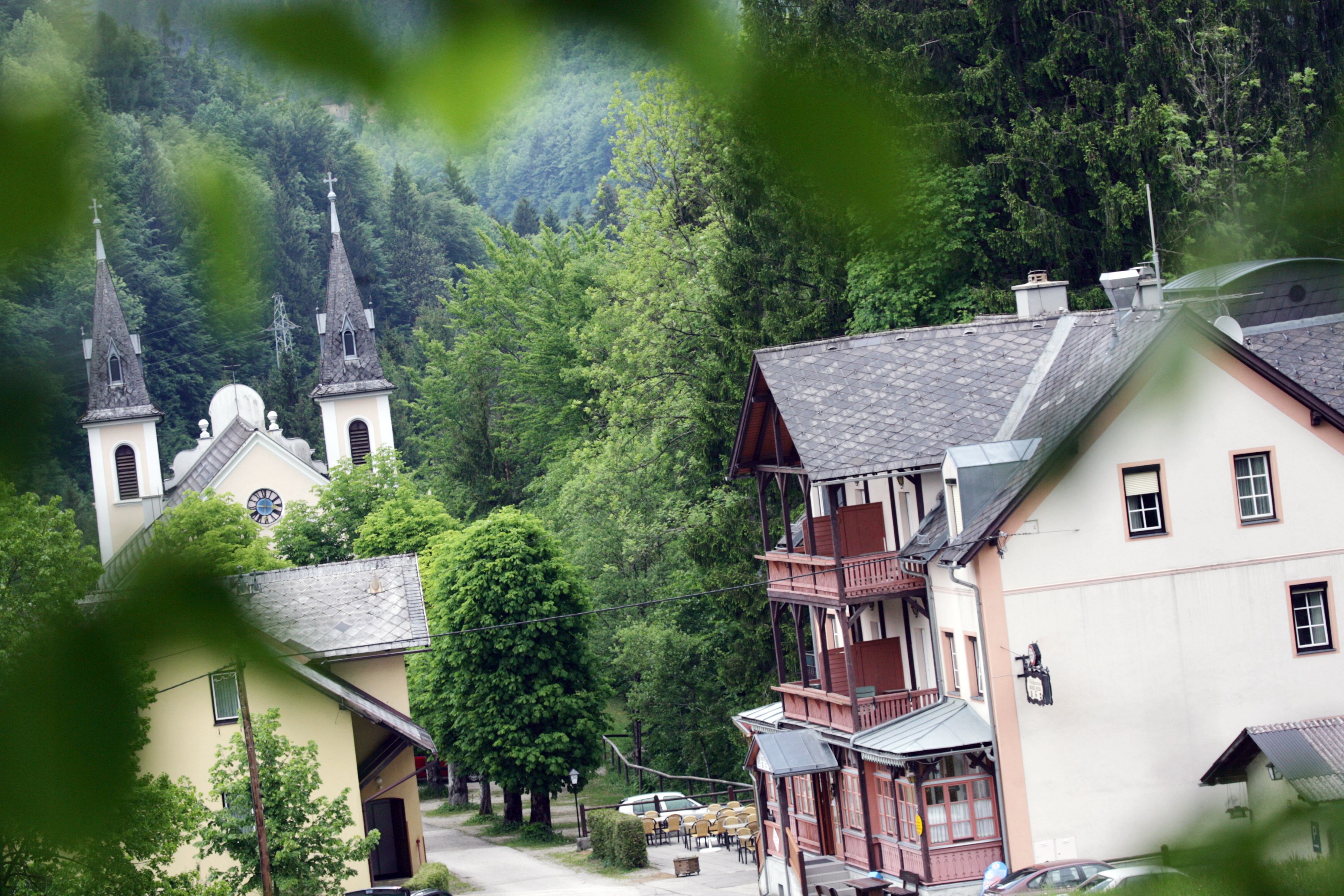 Wallfahrtskirche Maria Seesal mit umliegenden Gebäuden und Wald im Hintergrund.