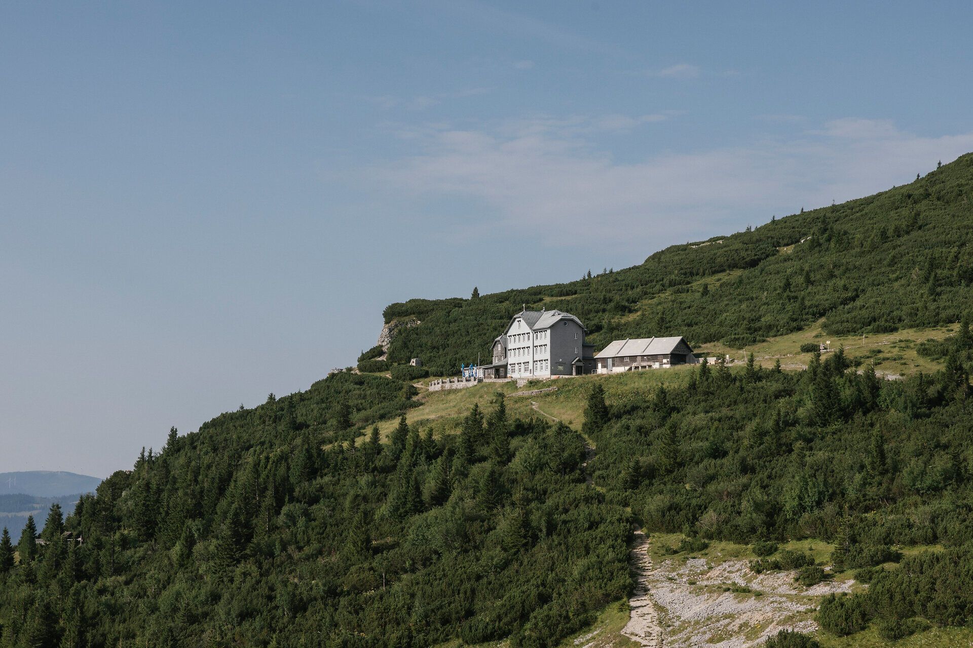 Weitblick auf das Ottohaus auf der Rax inmitten bewaldeter Berghänge