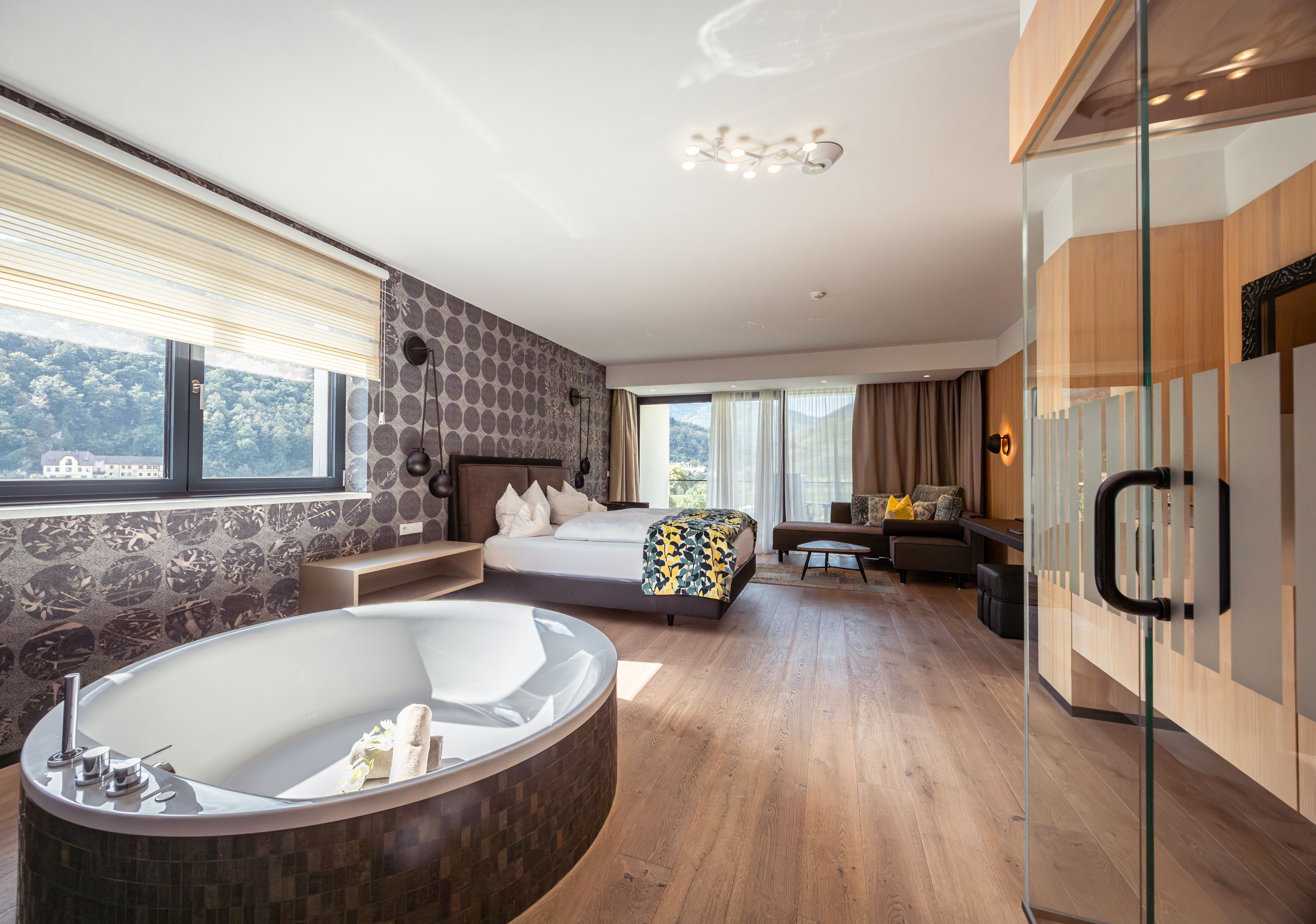 Außenansicht eines modernen Hotels mit Pool und Liegestühlen.