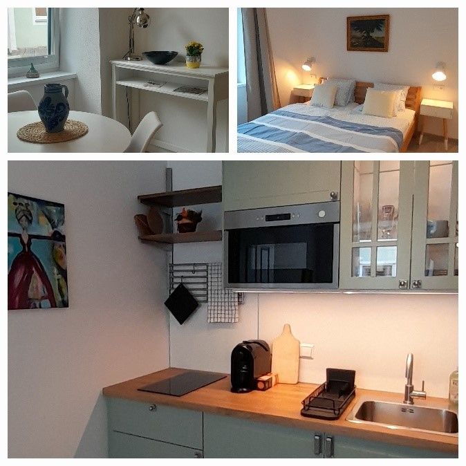 Innenansicht eines kleinen Apartments mit Essbereich, Schlafzimmer und Küche.