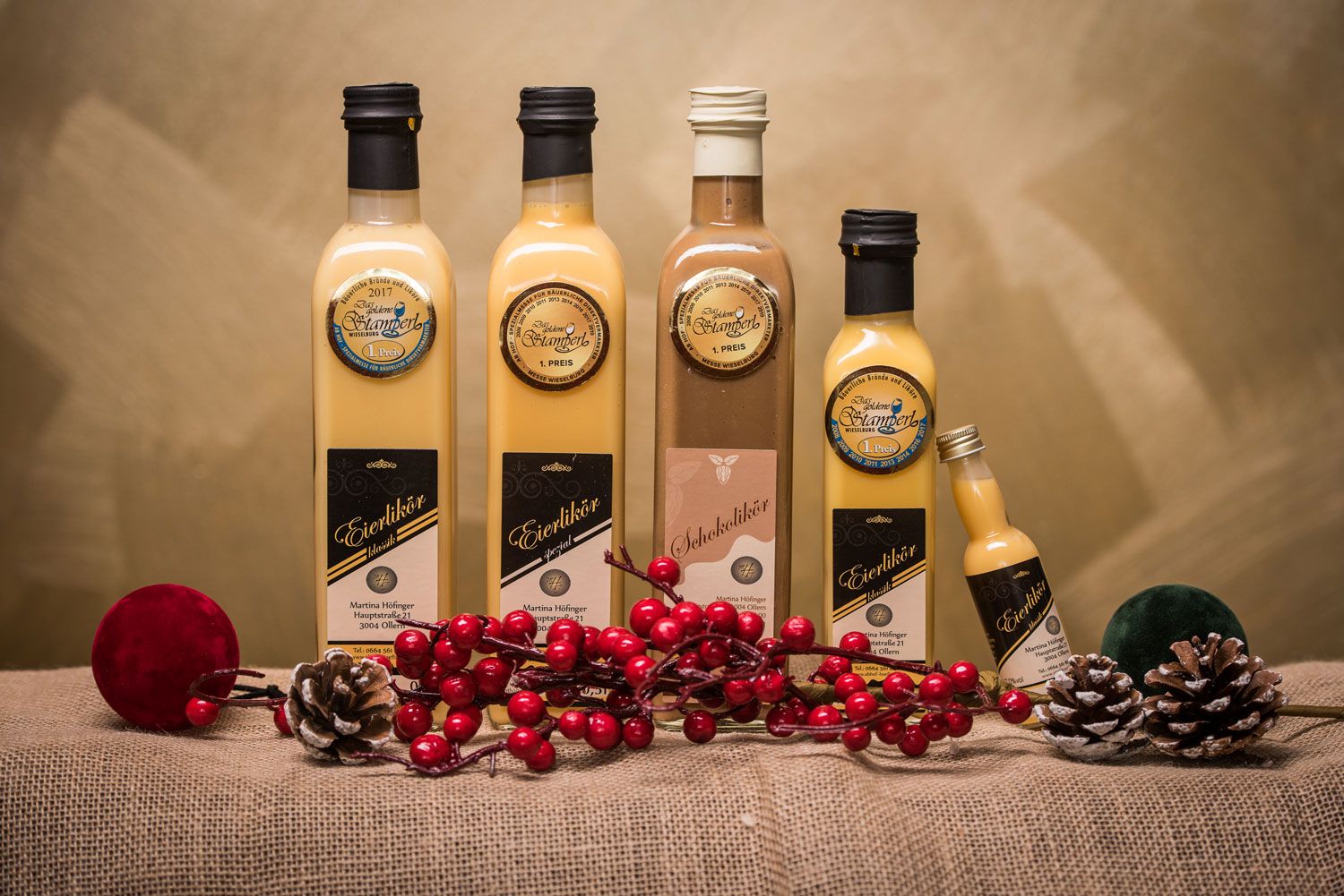 Flaschen mit Eierlikör und Schokolikör auf Jute mit Dekoration.