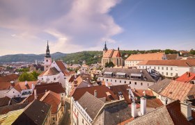 Panoramablick auf die Altstadt von Krems mit Kirchen und roten Dächern.