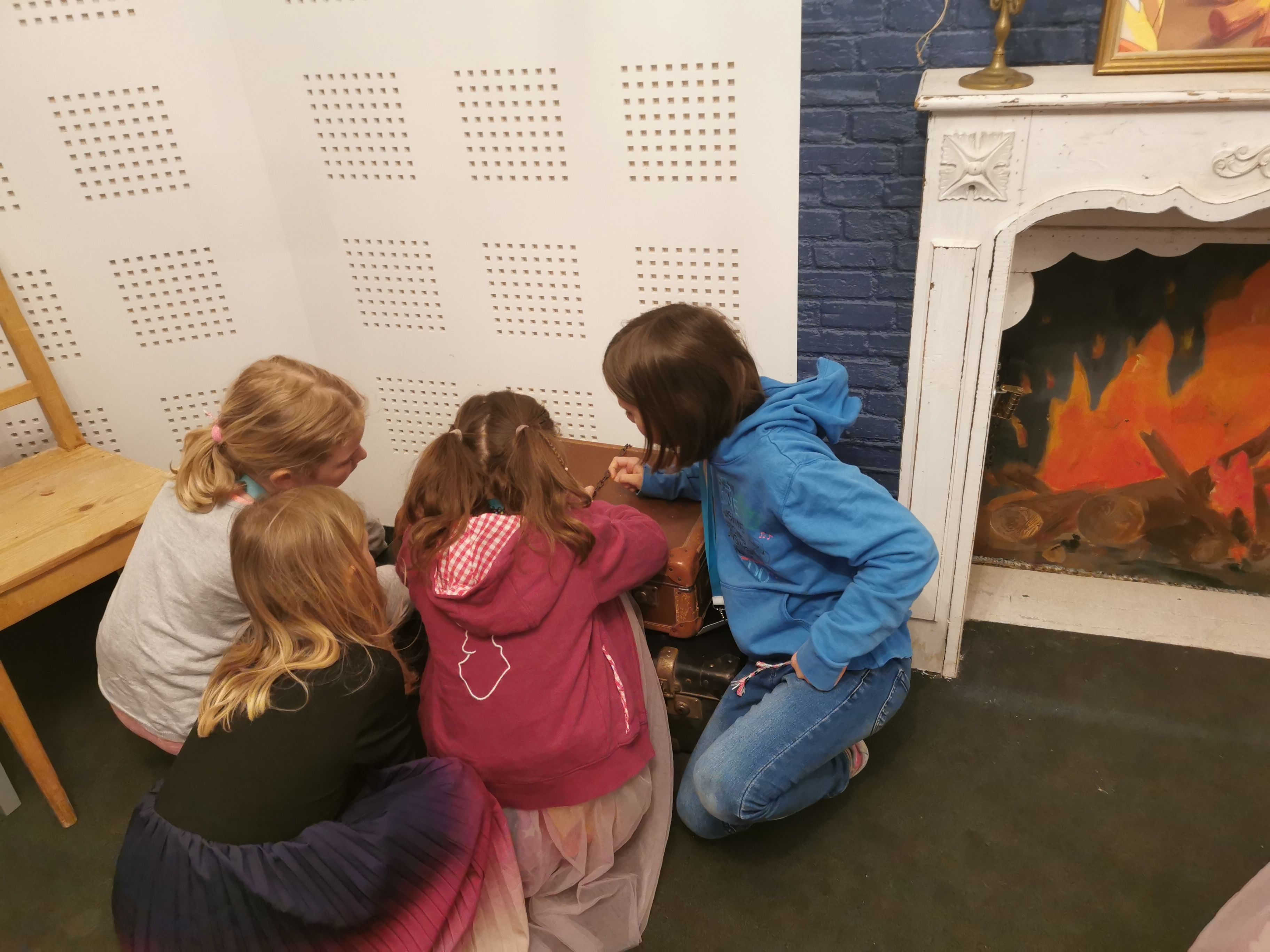 4 Kinder sitzen am Boden und lösen ein Rätsel 