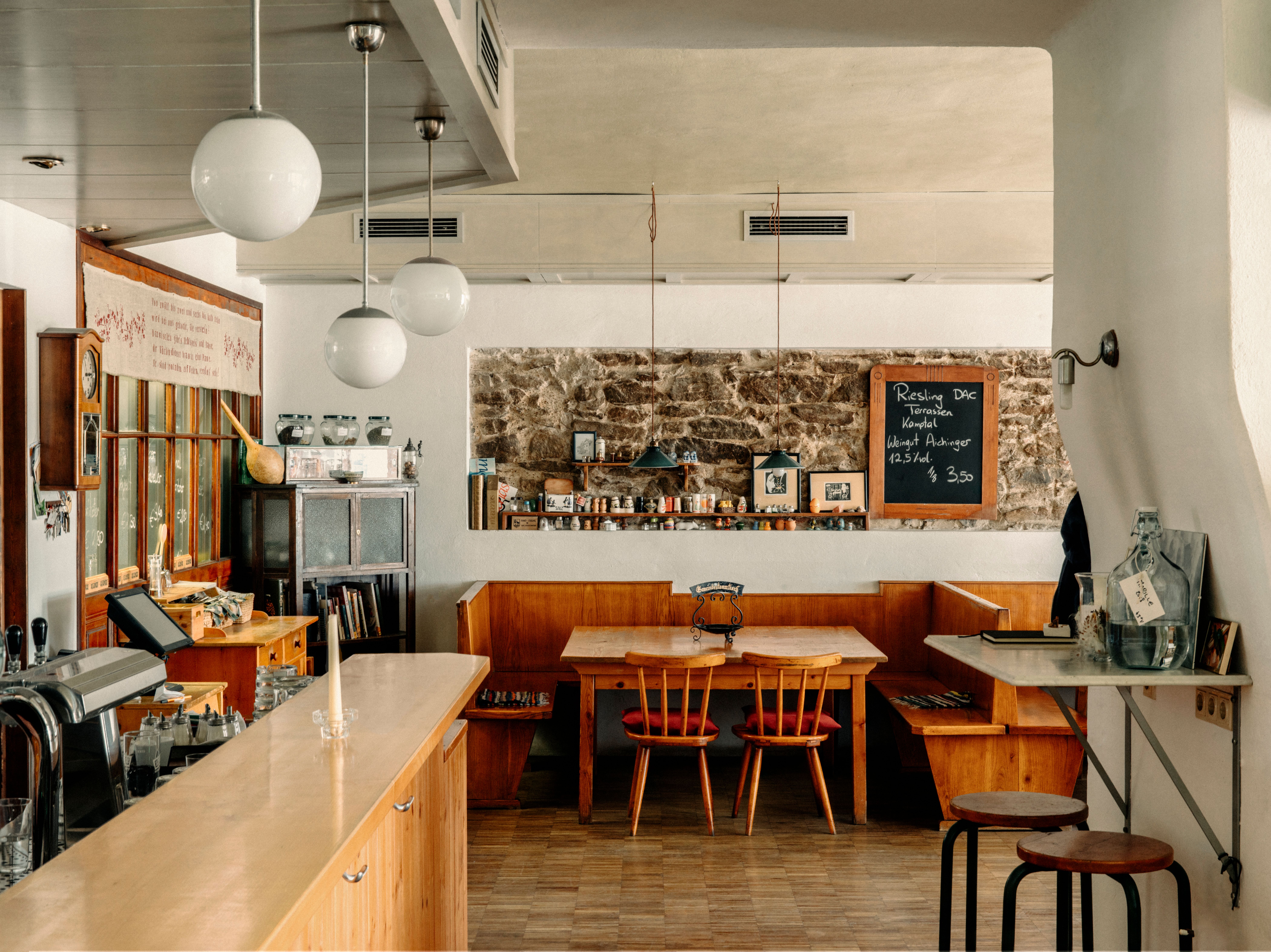 Drei Personen in traditioneller Kleidung in einem hellen Raum.