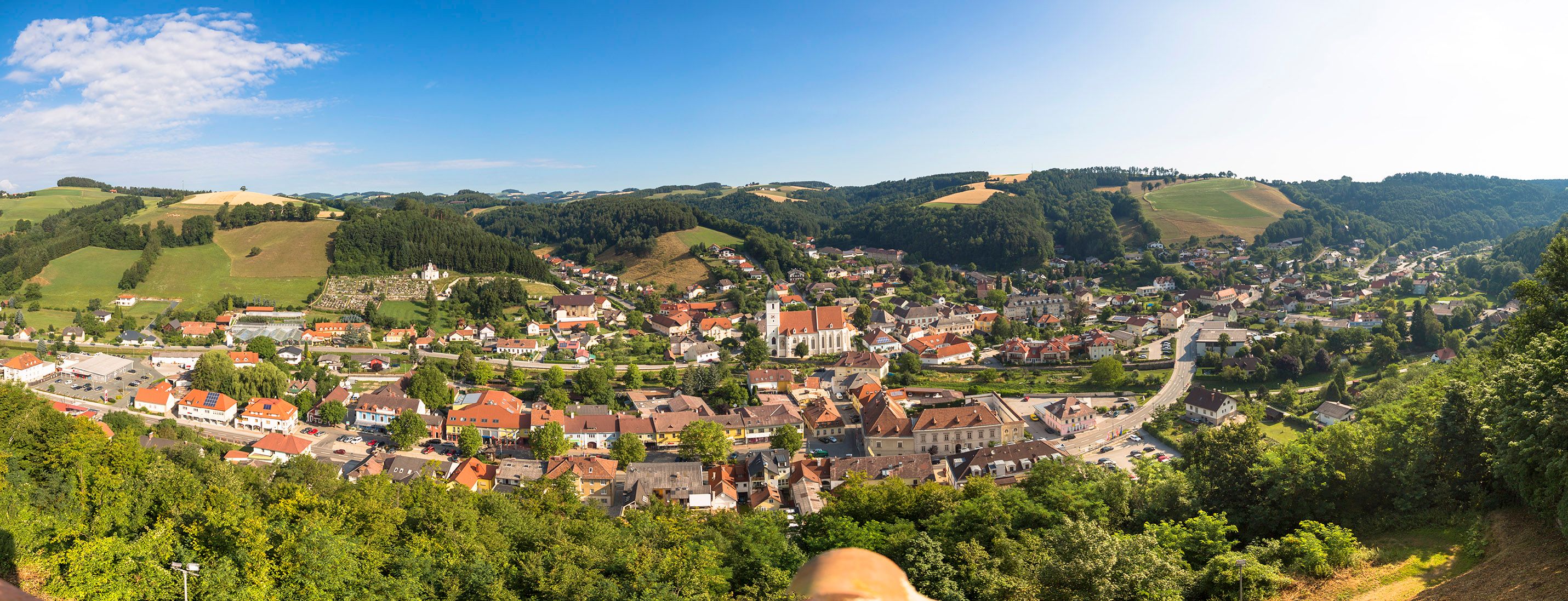 Panoramablick auf Kirchschlag in der Buckligen Welt, umgeben von Hügeln und Wäldern.
