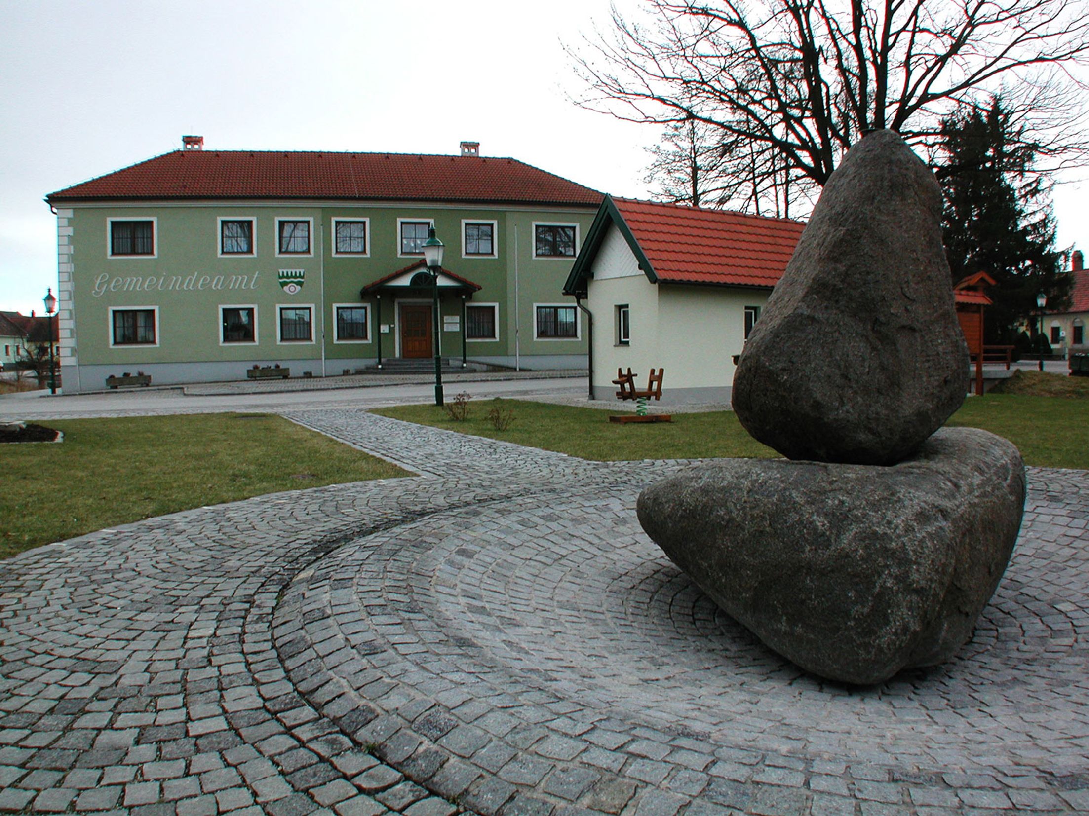 Gemeindeamt Großdietmanns mit Steinplastik im Vordergrund.