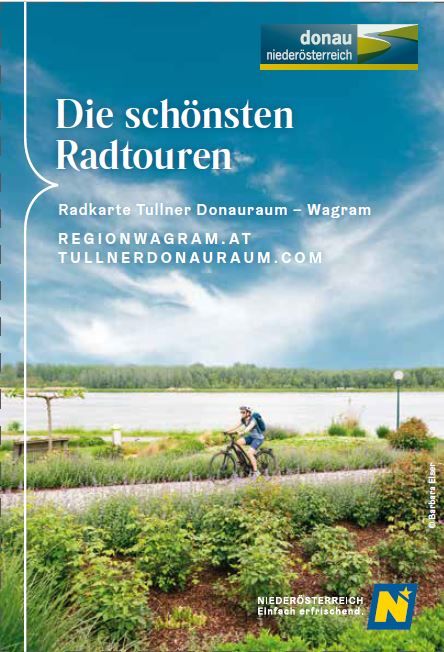 Coverbild: Person fährt auf dem Donauradweg durch die begrünte Donaulände von Tulln an der Donau. 