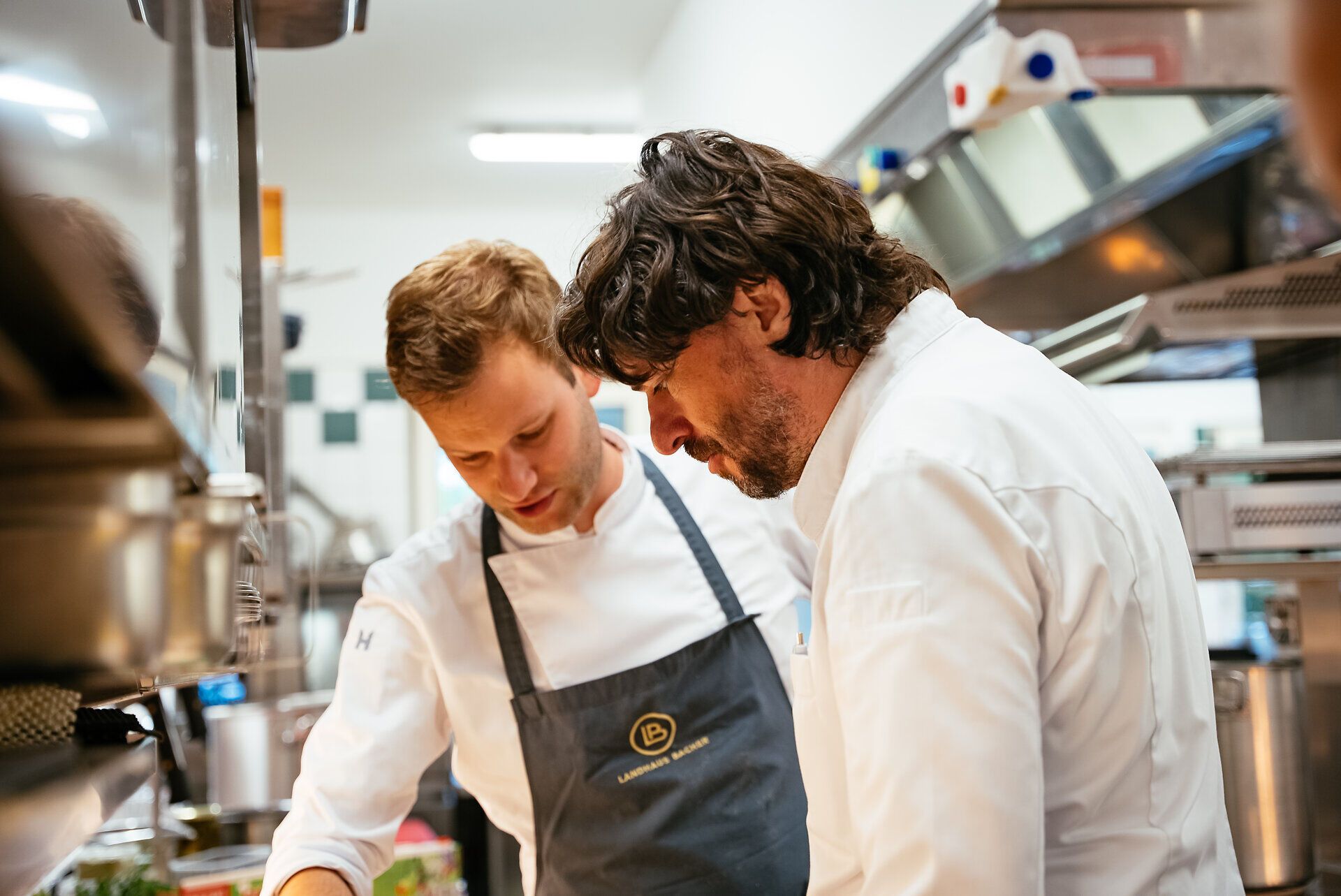 In der lebhaften Küche des Landhaus Bacher arbeiten talentierte Köche Hand in Hand, um exquisite Gerichte zu kreieren. Der Duft frischer Kräuter und regionaler Zutaten erfüllt den Raum und verspricht ein unvergessliches kulinarisches Erlebnis.
