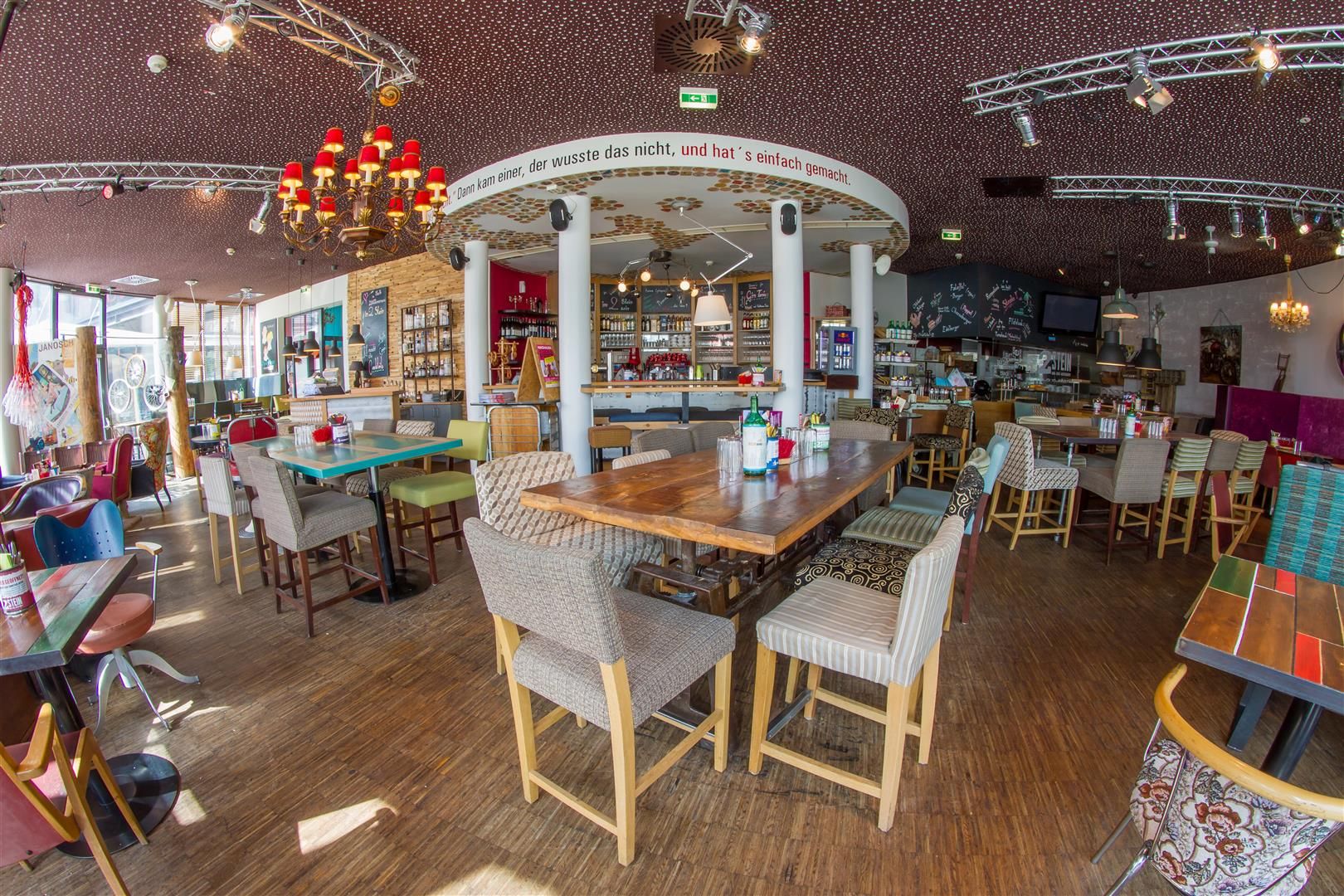 Innenraum eines stilvollen Cafés mit Holzmöbeln und dekorativen Elementen.