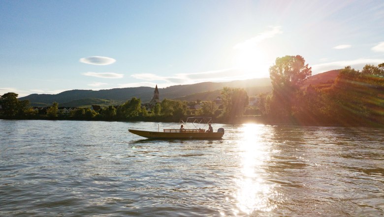 Boot auf einem Fluss bei Sonnenuntergang in der Wachau.