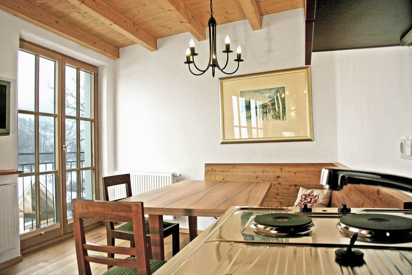 Gemütliches Gästezimmer mit Holzmöbeln und Küchenzeile.