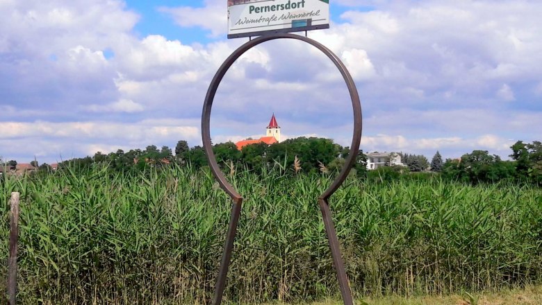 Blick durch eine Schlüsselform auf eine Kirche in Pernersdorf.