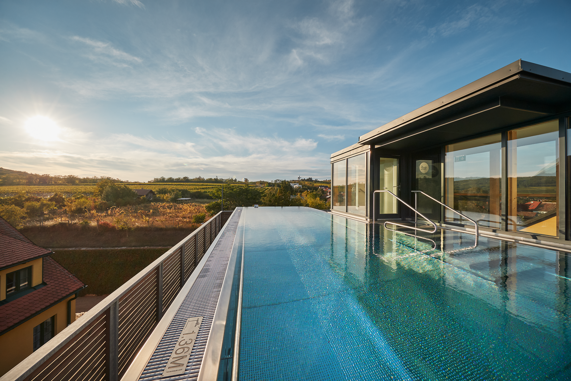 Genießen Sie den atemberaubenden Blick über die sanften Weinberge, während die Sonne am Horizont untergeht. Der glitzernde Pool lädt zum Entspannen ein und verspricht unvergessliche Momente inmitten der idyllischen Landschaft.