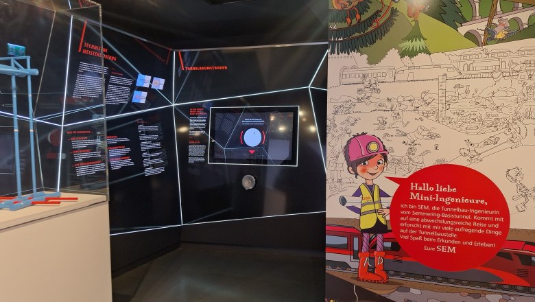 Ausstellung über den Semmering-Basistunnel mit Infotafeln und Kinderillustration.