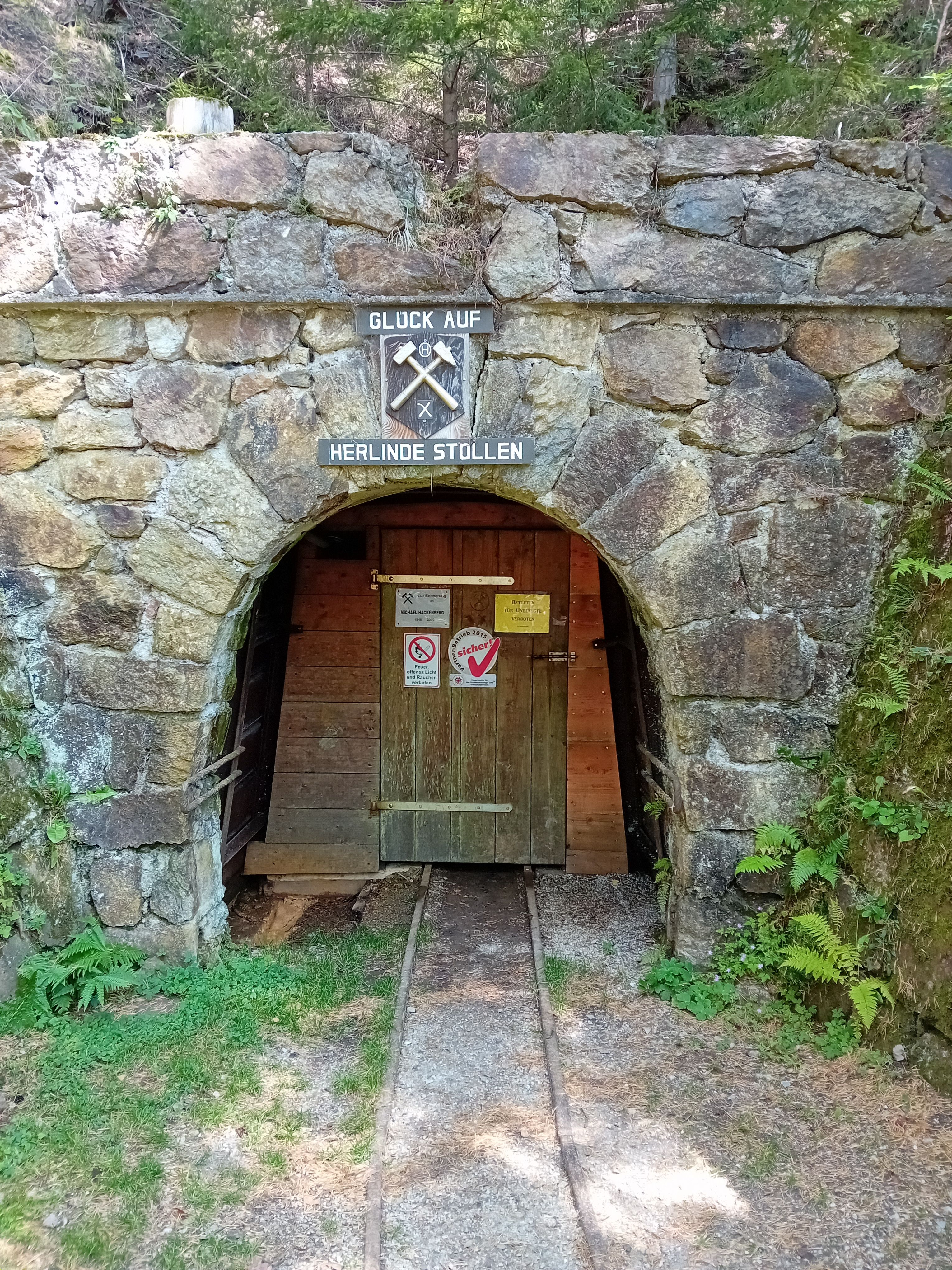 Eingang des Herlinde-Stollens mit Schild 'Glück Auf'.