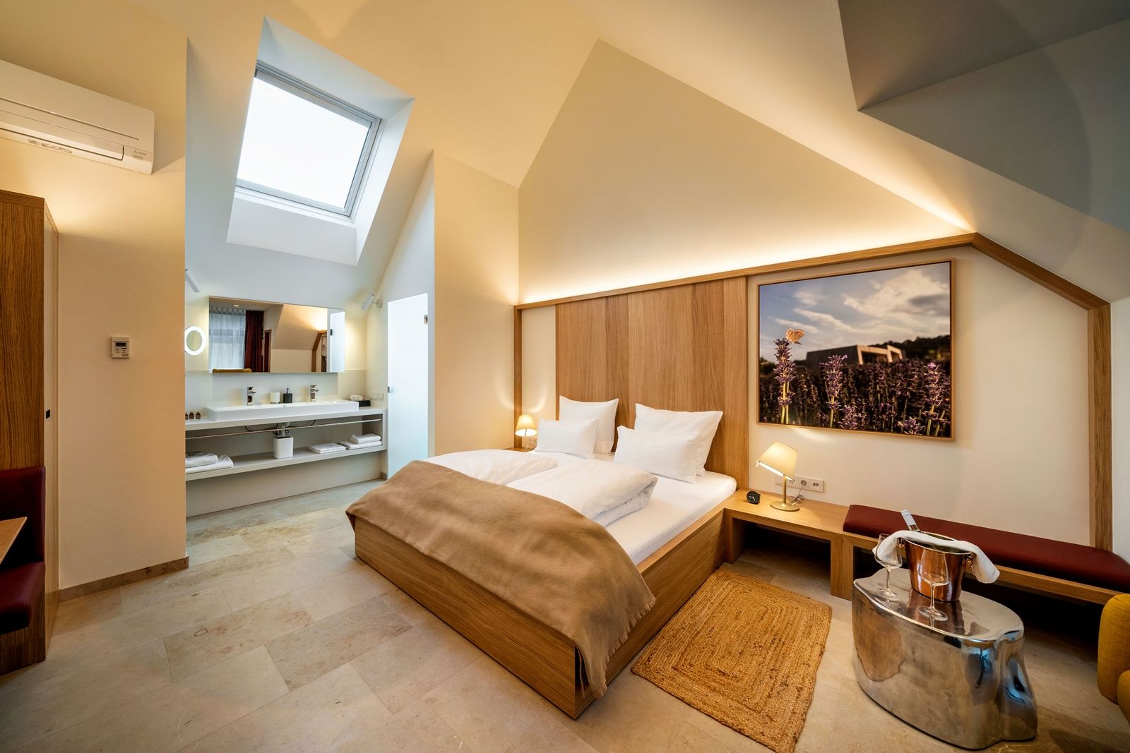 Modernes Hotelzimmer mit Dachfenster, Doppelbett und stilvoller Einrichtung.