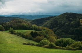 Die sanften H&uuml;gel und &uuml;ppigen W&auml;lder laden zu unvergesslichen Wanderungen ein. Hier, wo die Natur in voller Pracht erbl&uuml;ht, k&ouml;nnen Besucher die frische Bergluft genie&szlig;en und die Seele baumeln lassen.