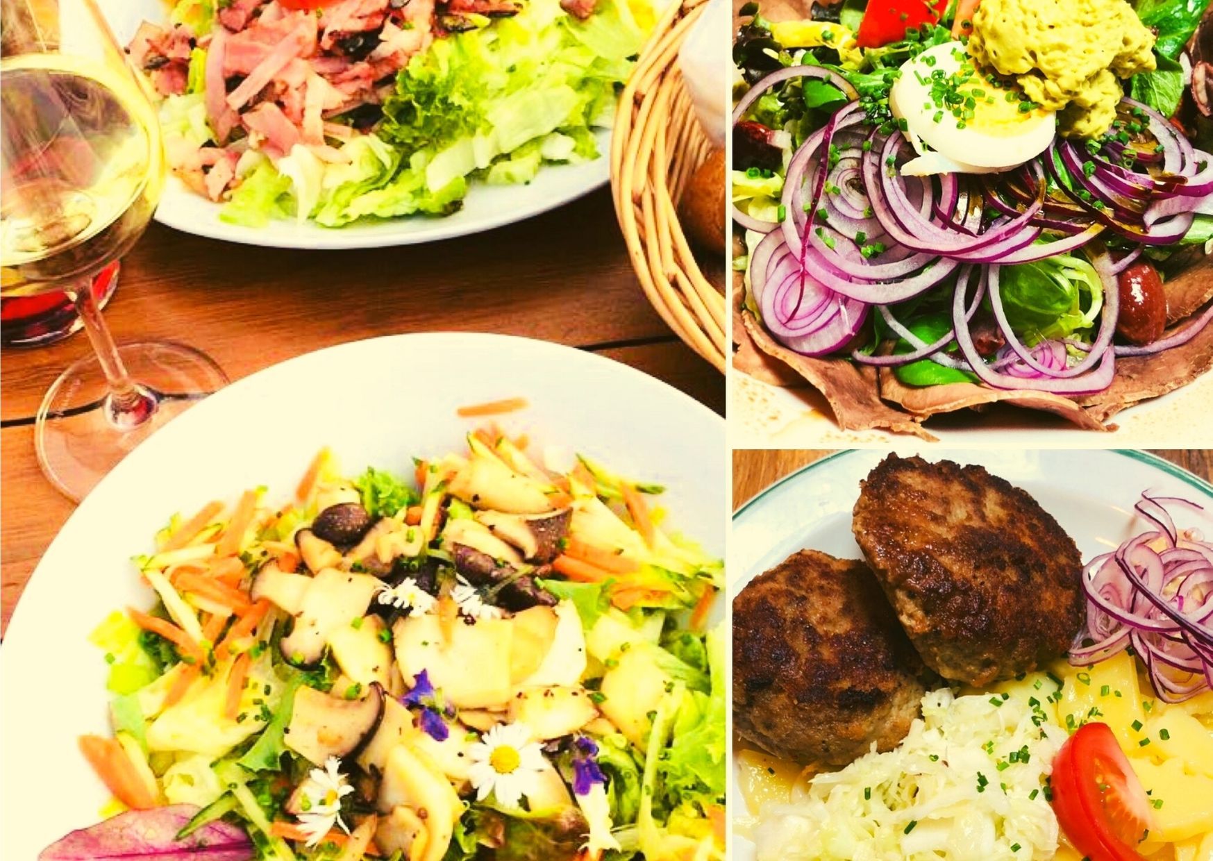 Verschiedene Teller mit Salaten, Fleisch und einem Glas Weißwein.