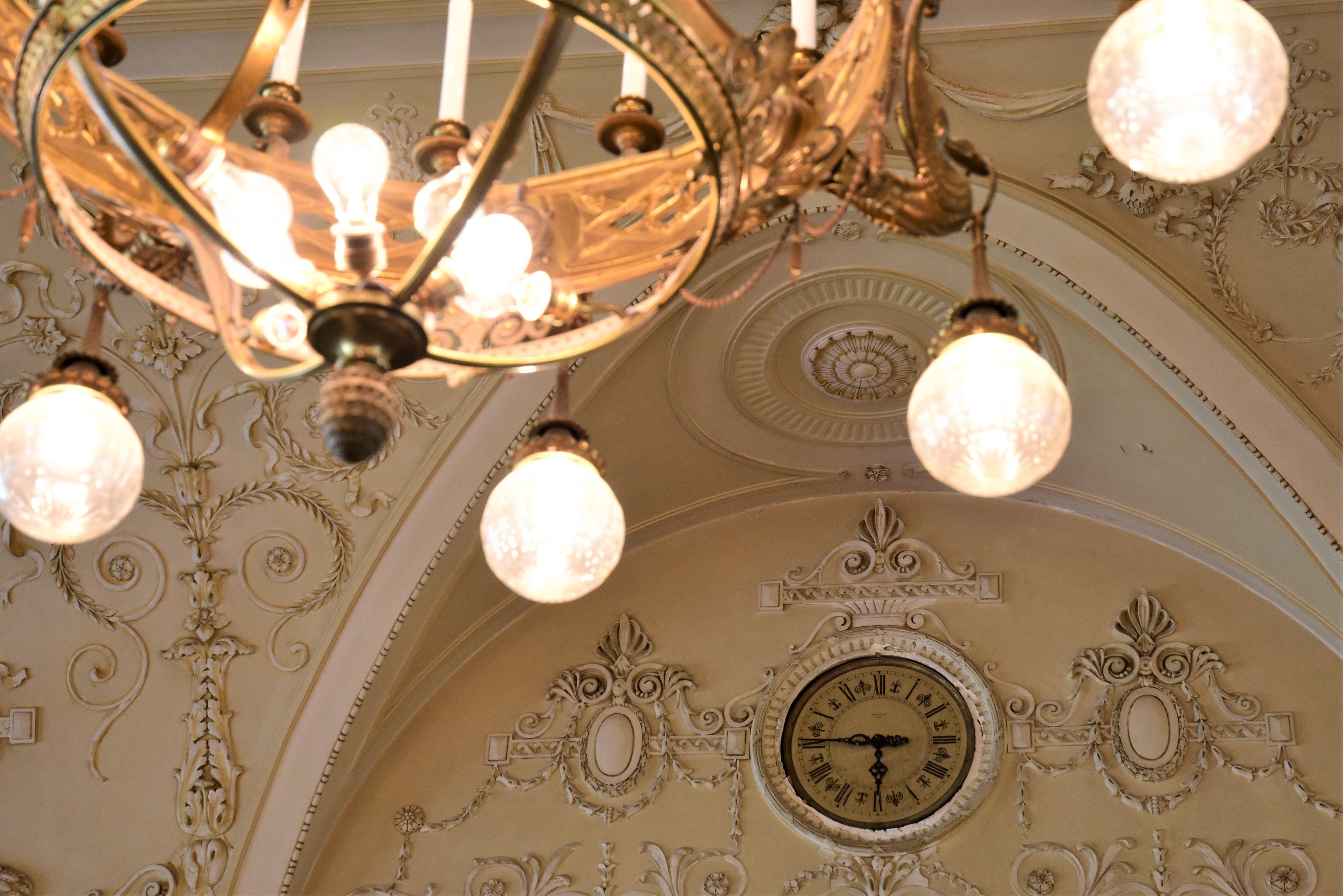 Detailaufnahme einer dekorativen Decke mit Kronleuchter und Uhr im Südbahnhotel.
