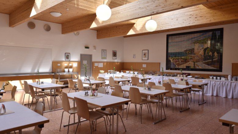 Frühstücksraum aufgedeckt mit Tischen für eine Gruppe