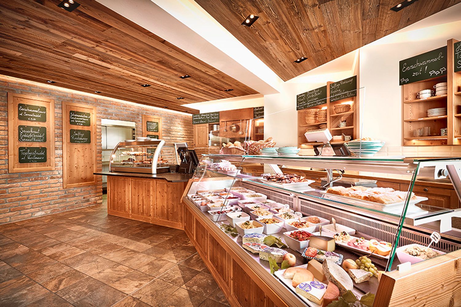Innenansicht eines Heurigenlokals mit Theke und Speisen.