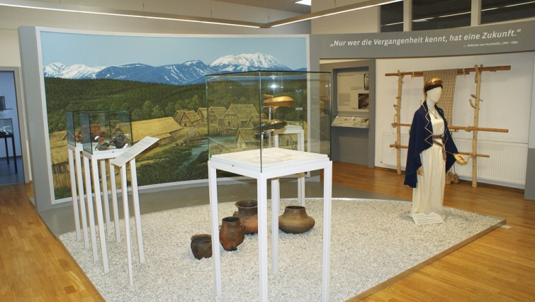 Innenansicht des Pittener Regionsmuseums mit Ausstellungsst&uuml;cken und Wandgem&auml;lde.
