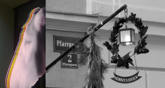 Ein Eselskopf mit bunten Streifen neben einem Stra&szlig;enschild und einer Laterne mit Kranz.