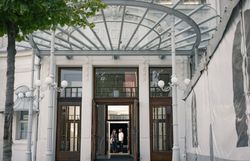 Ein Paar verlässt nach einer Veranstaltung die historische Sommerarena Baden, ein beeindruckendes Bauwerk. 