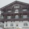 Ein gro&szlig;es, traditionelles Geb&auml;ude im Schnee, beschriftet mit 'Schneeberghof'.