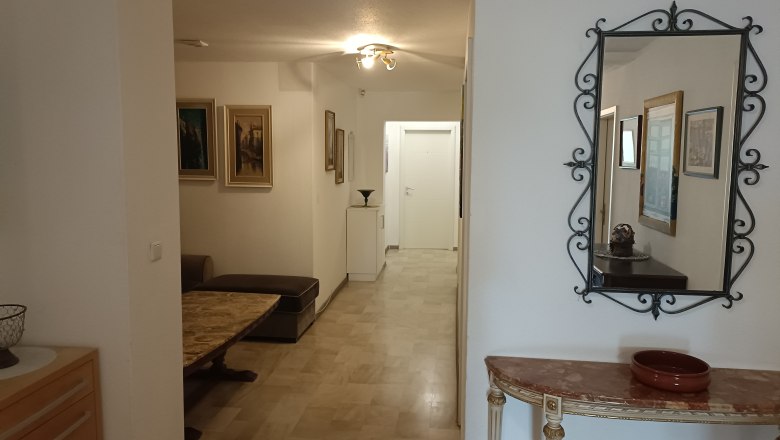 Flur mit Spiegel, Gem&auml;lden und M&ouml;beln in einem Gasthof.