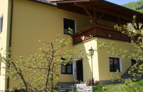 Gelbes Haus mit blühendem Baum